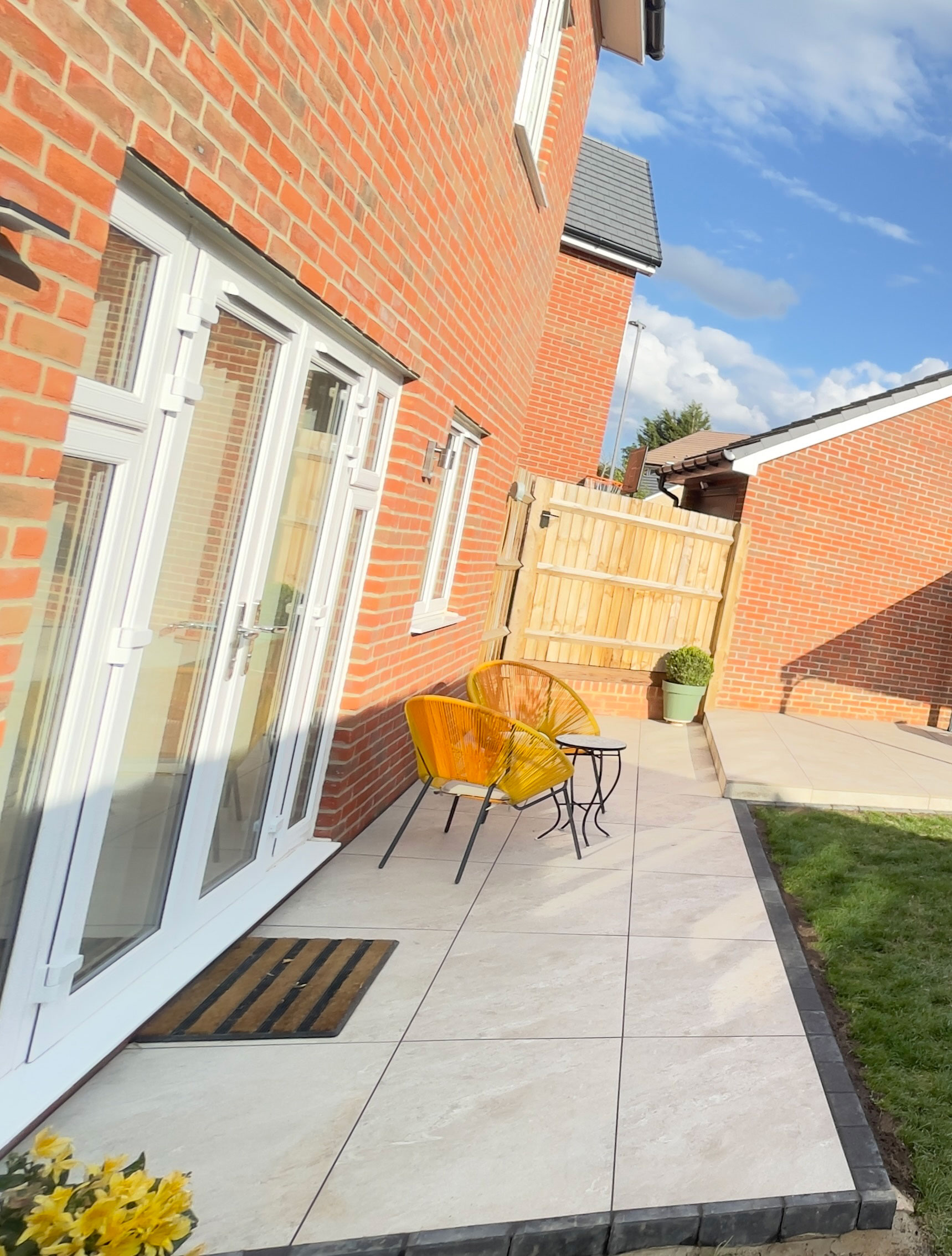 New-build garden with porcelain patio and flower borders — Eagles Farm